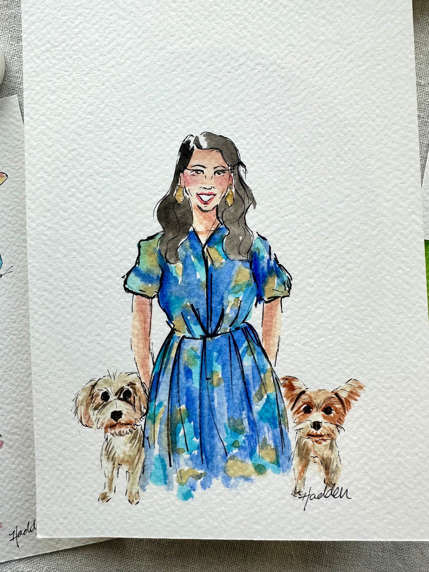 Watercolor illustration portrait of woman with brown hair and blue dress with two small dogs