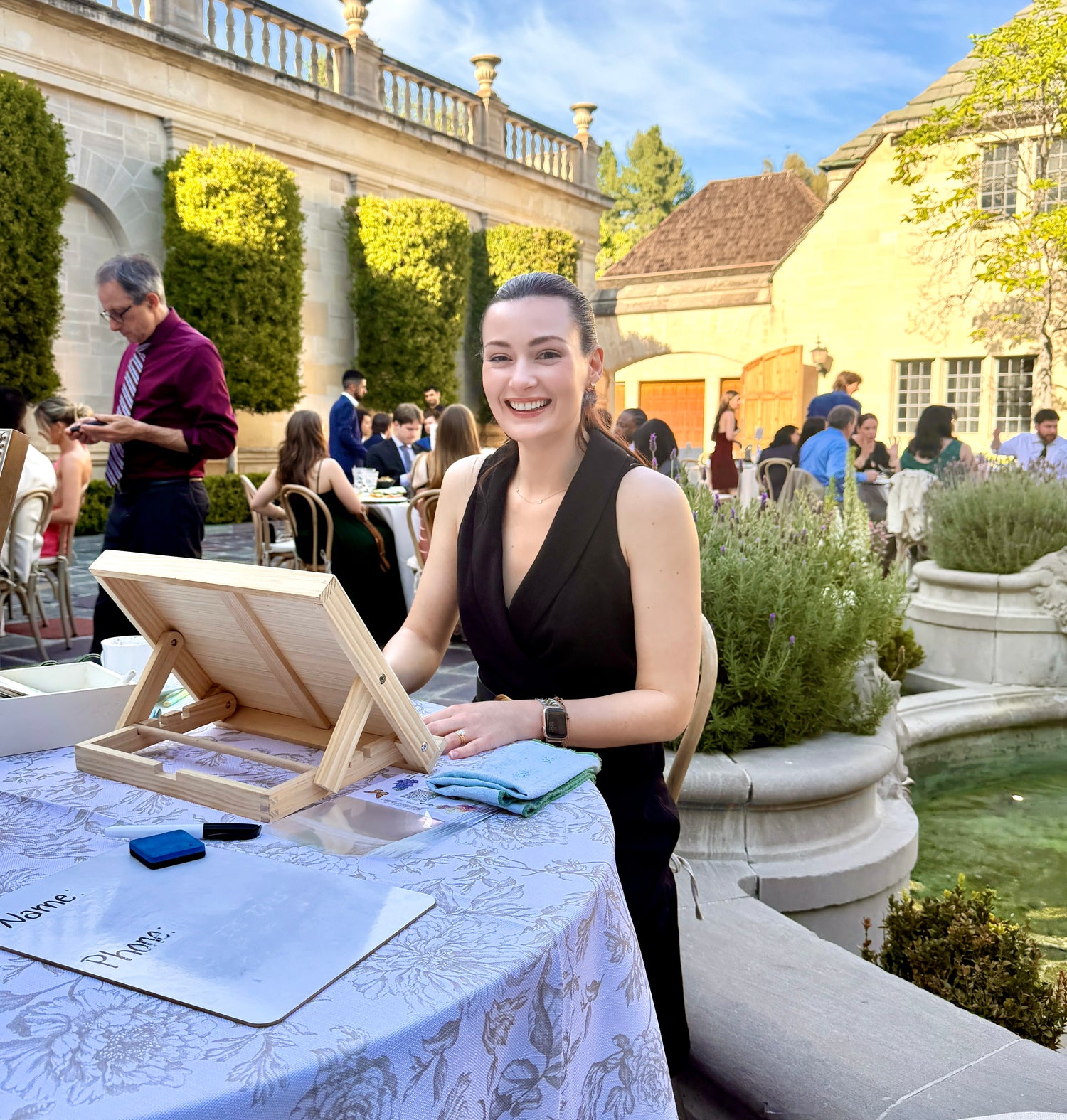 photo of artist sitting at table working at wedding venue 